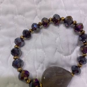 Iridescent purple beads with gold balls separating stones